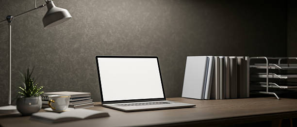 istock A modern dark loft office workspace features a laptop and decorative items on a wooden desk. 2200087951