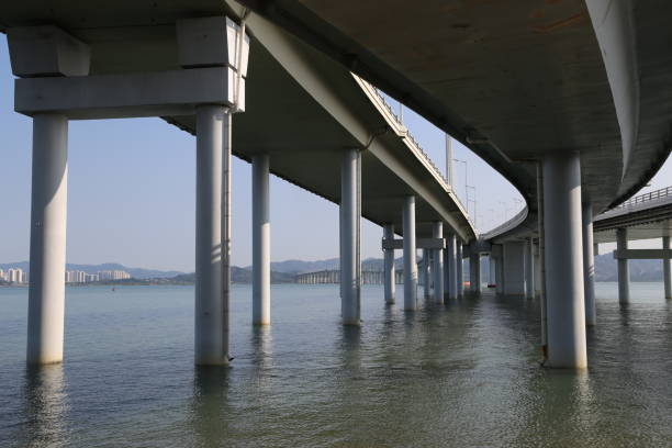istock A bridge over the sea, with white pillars and concrete structures 2200088671