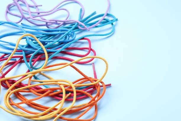 istock Many colorful shoe laces on light blue background, closeup. Space for text 2200091358