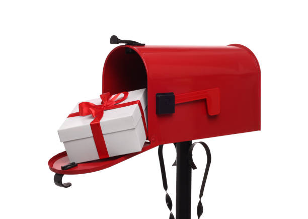 istock Red mailbox with Christmas gift isolated on white. Sending present by mail 2200095125
