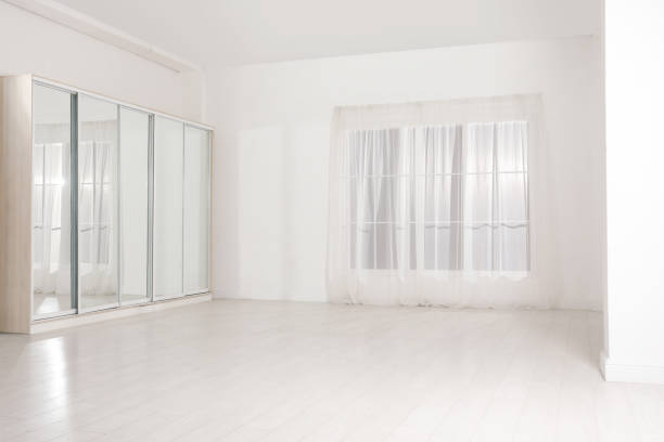 istock Empty room with white walls and large window 2200095172
