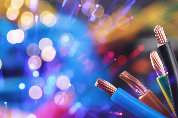 istock Colorful electrical wires against color background with blurred lights, closeup. Space for text 2200095189