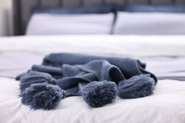 istock Soft blue plaid on bed in room, closeup 2200095241