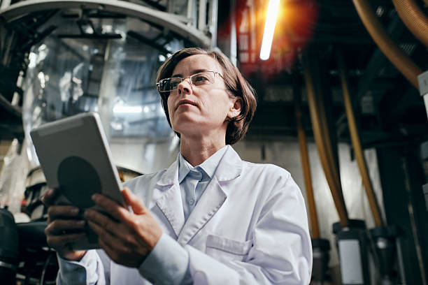 istock Serious female engineer with tablet working at the factory 2200097649