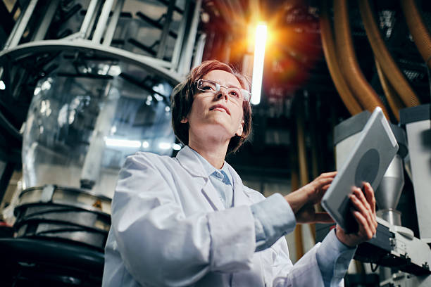 istock Thoughtful female engineer with tablet working at the factory 2200097667