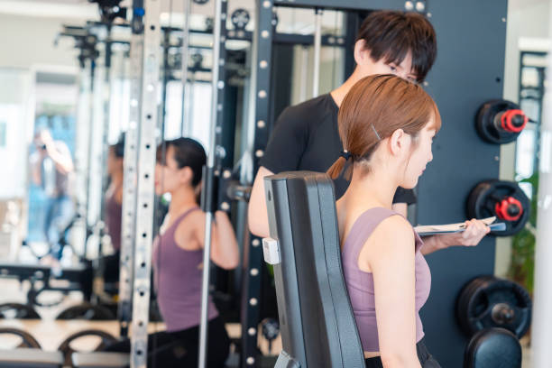 istock People who train on gym machines. 2200097993