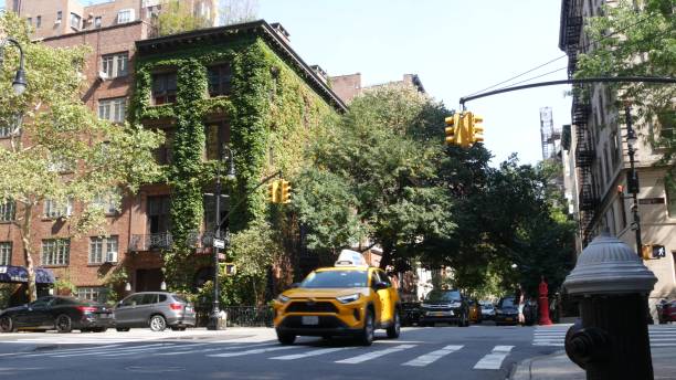 New York City Manhattan Irving street corner, Gramercy, USA. People, taxi cab. House wall, ivy plant New York City, United States, 6 Sept 2023: Manhattan Midtown Irving street corner, crossroad intersection, Gramercy, USA. People pedestrians. Yellow taxi. Red brick house wall covered ivy plant leaves grapevine texas city stock pictures, royalty-free photos & images