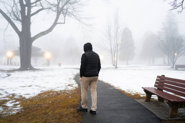 istock Man walking in a park in winter time 2200103326