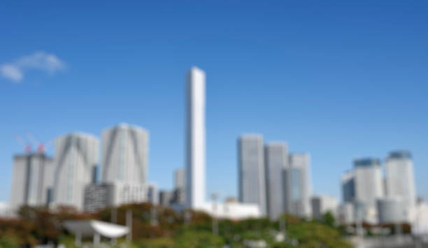 Defocused high rise residential apartment background against clear sky.