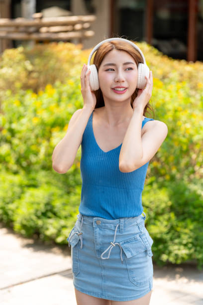 istock Young Woman with Headphone Outdoors 2200105334