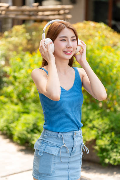 istock Young Woman with Headphone Outdoors 2200105347