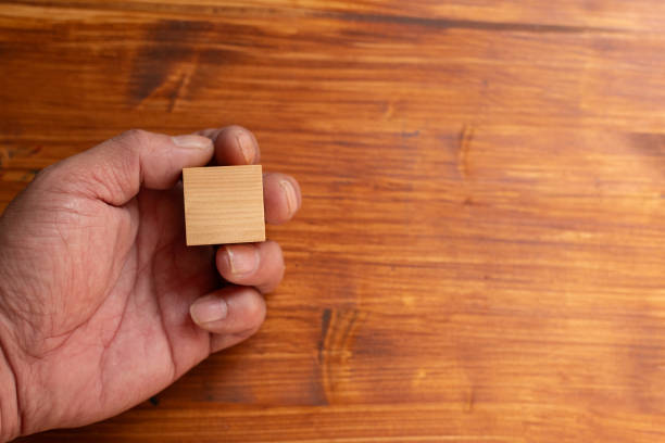 istock Person holding a wooden block 2200107467