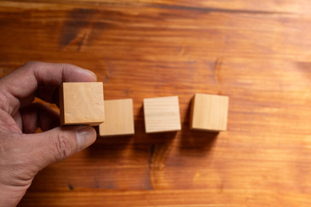 istock Person holding a wooden block 2200107496