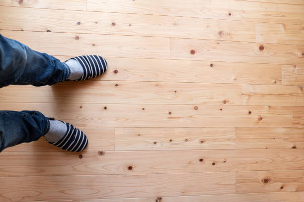 Standing barefoot on a wooden walkway