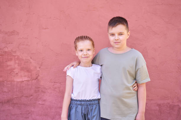 A picture of boy and girl casual clothes posing emotions studio isolated background