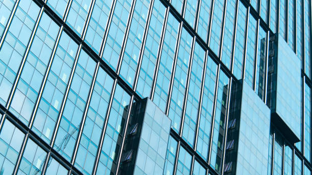 istock A stunning architectural pattern of glass panels reflecting the sky, creating a mesmerizing interplay of symmetry, lines, and light 2200110638