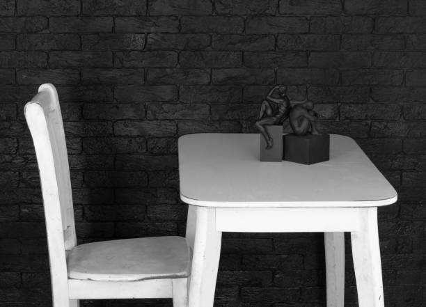 interior white table with decorations and white chair in black room