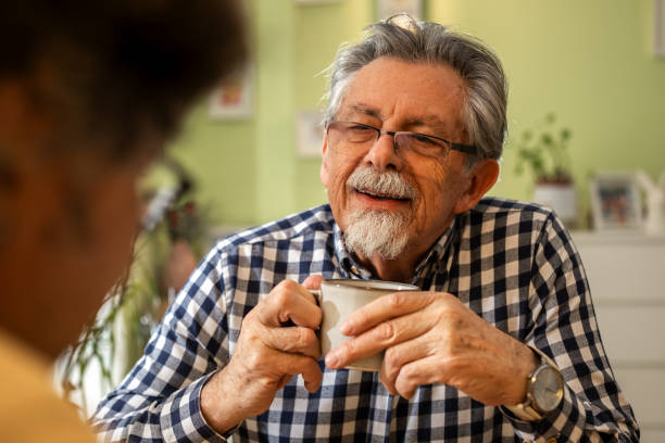 istock Two men enjoying coffee and conversation at home 2200120338