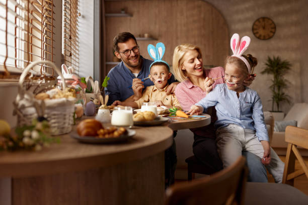 istock Happy family enjoying in creative time on Easter at home. 2200120525