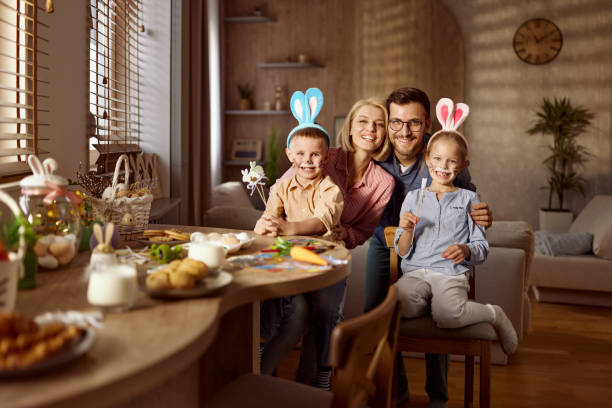istock Happy parents and their kids enjoying on Easter at home. 2200120870