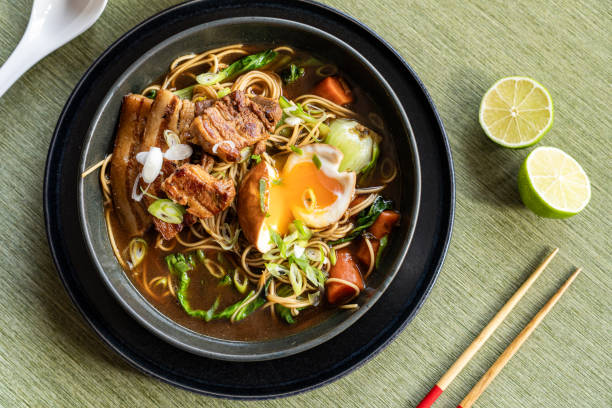 istock Steaming ramen bowl presenting sliced pork belly, marinated soft egg, and vibrant pak choi garnishing rich broth 2200124437