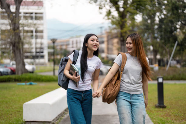 istock Students walking hand in hand, enjoying friendship and academic life on campus. 2200124903