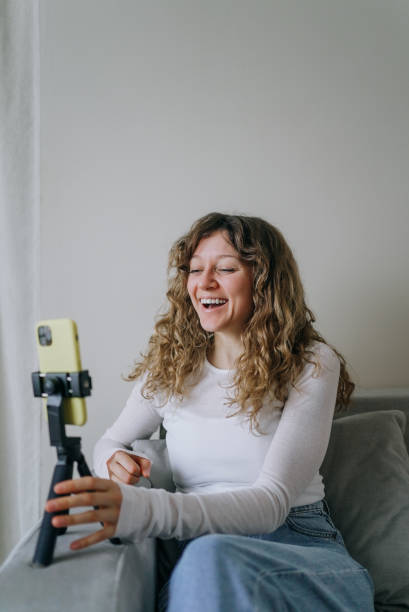 istock Influencer creating engaging content, laughing while recording video blog 2200124957