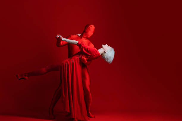 Photo of two ballet dancers practicing together on the stage of a theater.