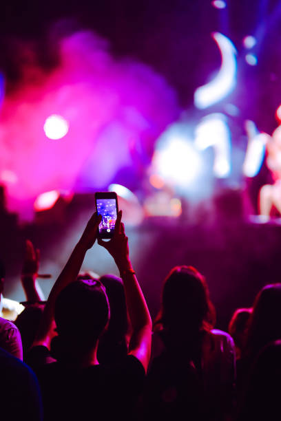 istock Hand held smart phone filming a concert. 2200126811