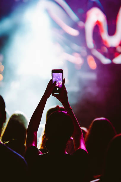 istock Hand held smart phone filming a concert. 2200126825