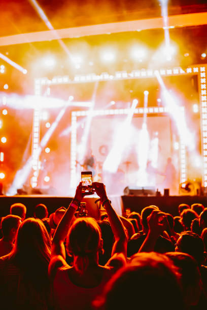 istock Hand held smart phone filming a concert. 2200126848