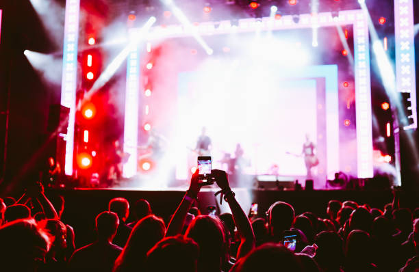 istock Hand held smart phone filming a concert. 2200126851
