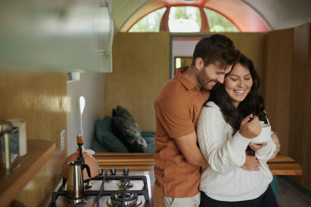 istock Home, couple and smile with hug in kitchen for affection, bonding and support as lovers. People, relationship and embrace in apartment for coffee break, relax and rest for care and love with romance 2200128599
