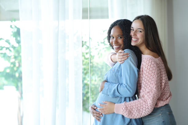 istock Happy interracial lesbian couple enjoying pregnancy 2200131050