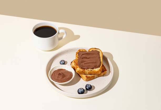 Toasted bread with chocolate cream on a plate with blueberry on a light  background