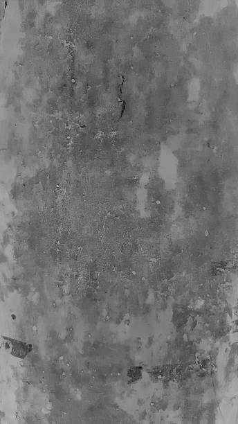 istock Large white grunge textured concrete wall background. The backdrop is a rough cement floor in gray tones. 2200132436