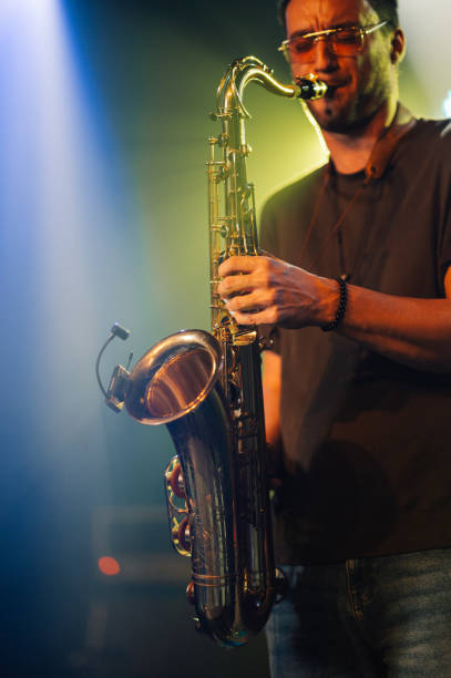 istock Saxophonist performing live on stage with passion 2200132440