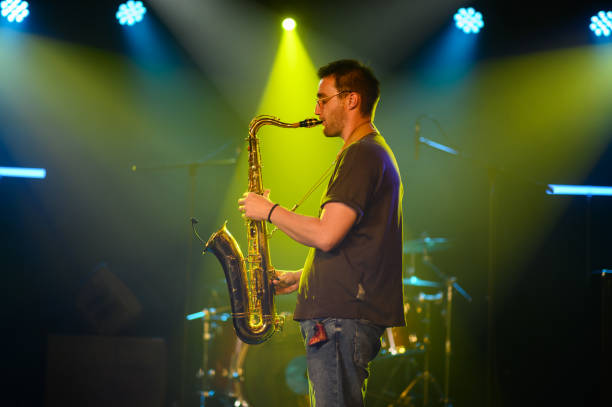 istock Saxophonist performing live on stage with passion and energy 2200132444