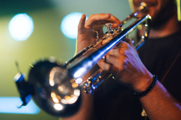 istock Musician playing trumpet on stage during live performance 2200132450