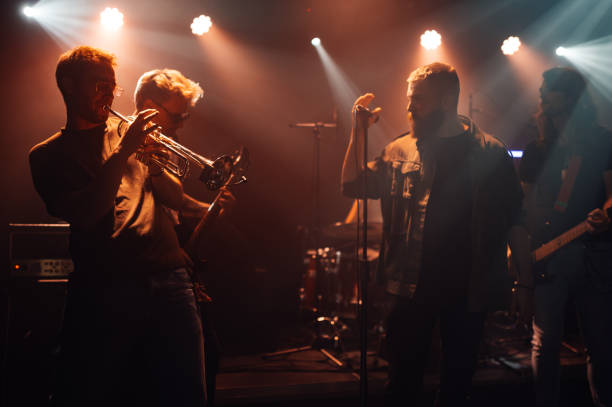 istock Band playing live music on stage with spotlights 2200132465