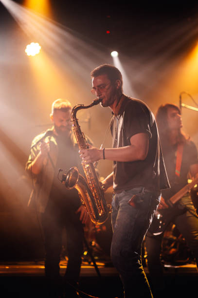 istock Saxophonist performing live with band on stage 2200132469