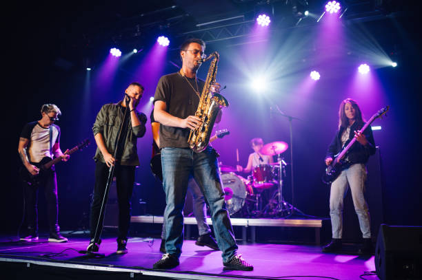 istock Music band playing live on stage under purple lights 2200132565