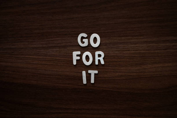 istock Go for it - Wooden letters on walnut background 2200133214