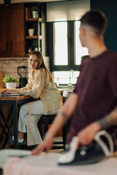 istock Lesbian couple sharing housework and working remotely from home 2200133597