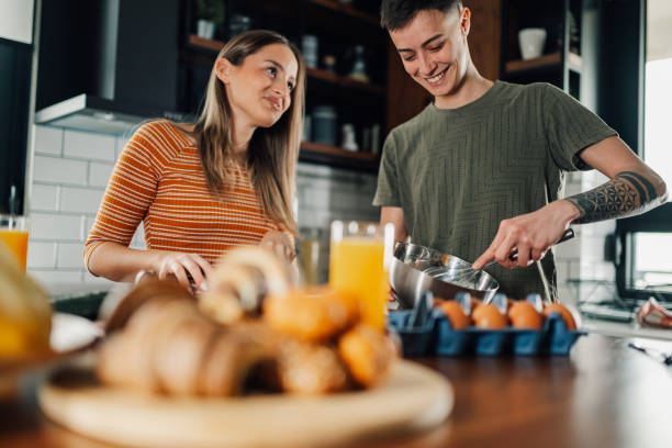istock Two lesbian lgbt women preparing breakfast in modern kitchen 2200133632