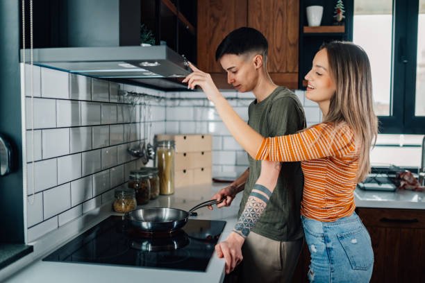 istock Lesbian couple cooking together in modern kitchen 2200133645