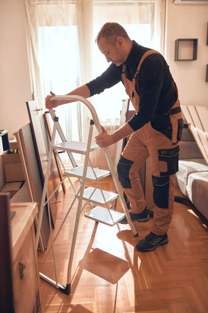 istock Carpenter working and assembling furniture in a new apartment. 2200136338