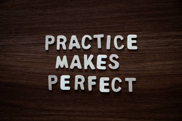 Practice makes perfect - Wooden letters on walnut background