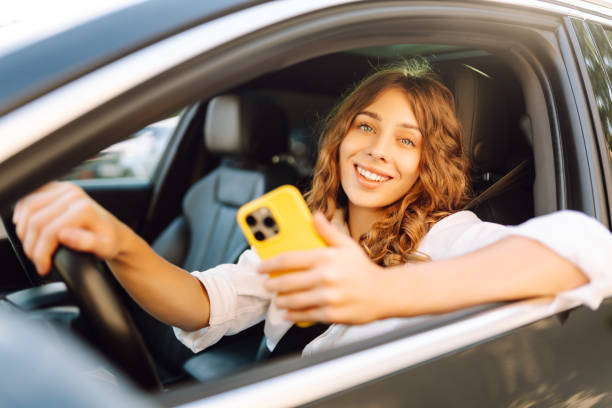 istock Female driver use smart phone in the car. 2200137786
