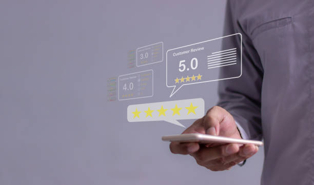 istock Customer Review, Young Man hand using smartphone mobile with five star to review and give 5 stars with very good results in service, Good review 5 star rating choice feedback 2200140328